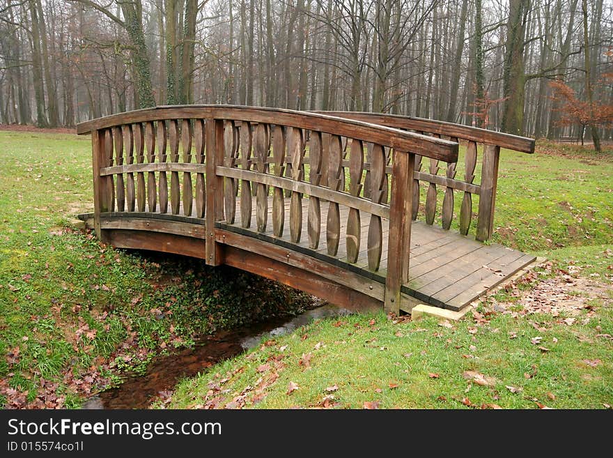 Wooden bridge with creek in autumn