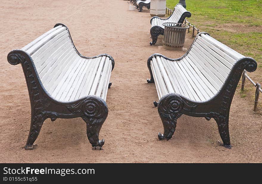 Two park benches standing opposite to each other. Two park benches standing opposite to each other