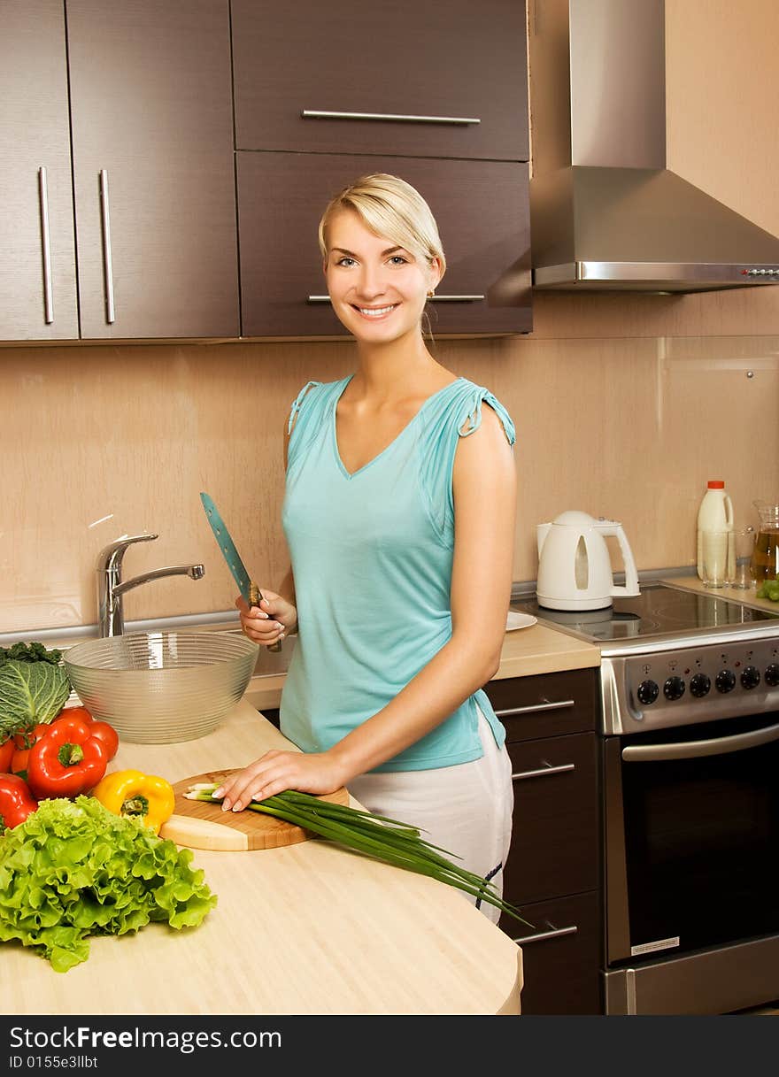 Beautiful young woman making vegetarian vegetable salad. Beautiful young woman making vegetarian vegetable salad