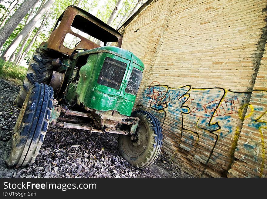 Abandoned tractor close to an old building. Abandoned tractor close to an old building.