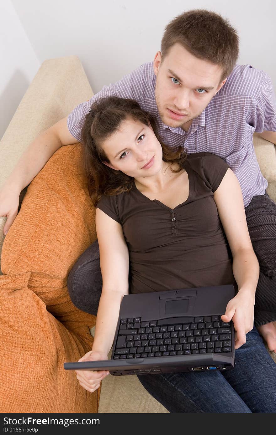 Casual loving couple on sofa with laptop. Casual loving couple on sofa with laptop