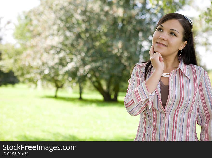 Attractive brunette woman in park. Attractive brunette woman in park