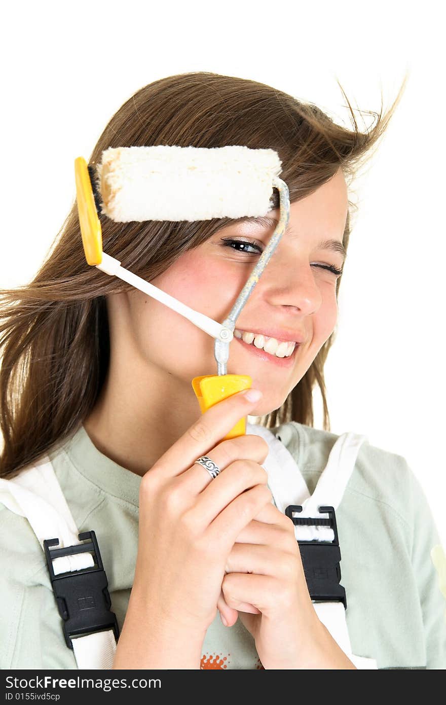 Close-up portrait of a teenager looking at the camera through a paint roller. She is isolated on a white background, space for text is provided on the right side. Close-up portrait of a teenager looking at the camera through a paint roller. She is isolated on a white background, space for text is provided on the right side.