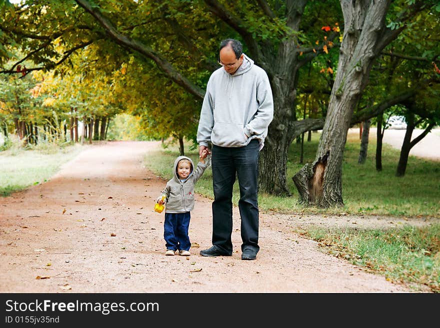 Father and son in autumn park