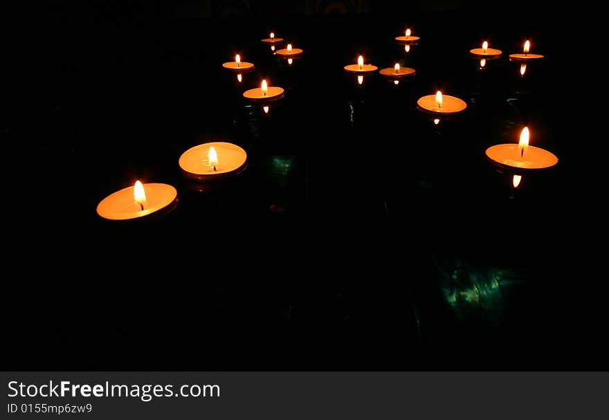 Collection of floating candles on water. Collection of floating candles on water