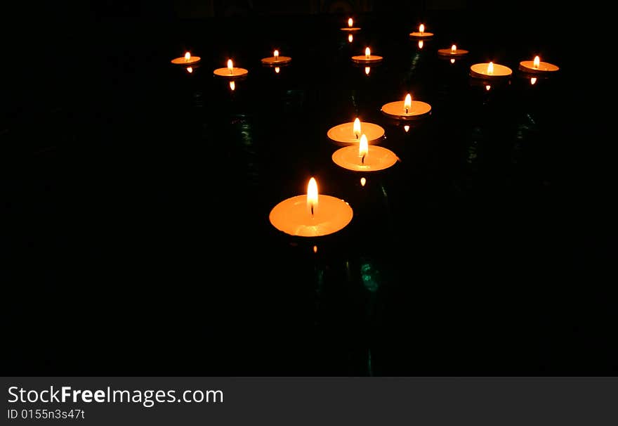 Collection of floating candles on water. Collection of floating candles on water