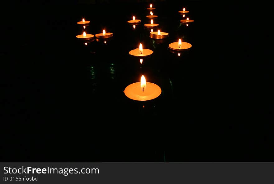 Collection of floating candles on water. Collection of floating candles on water