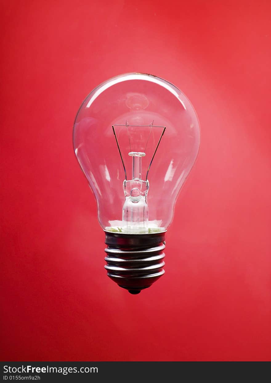 Lightbulb on red background