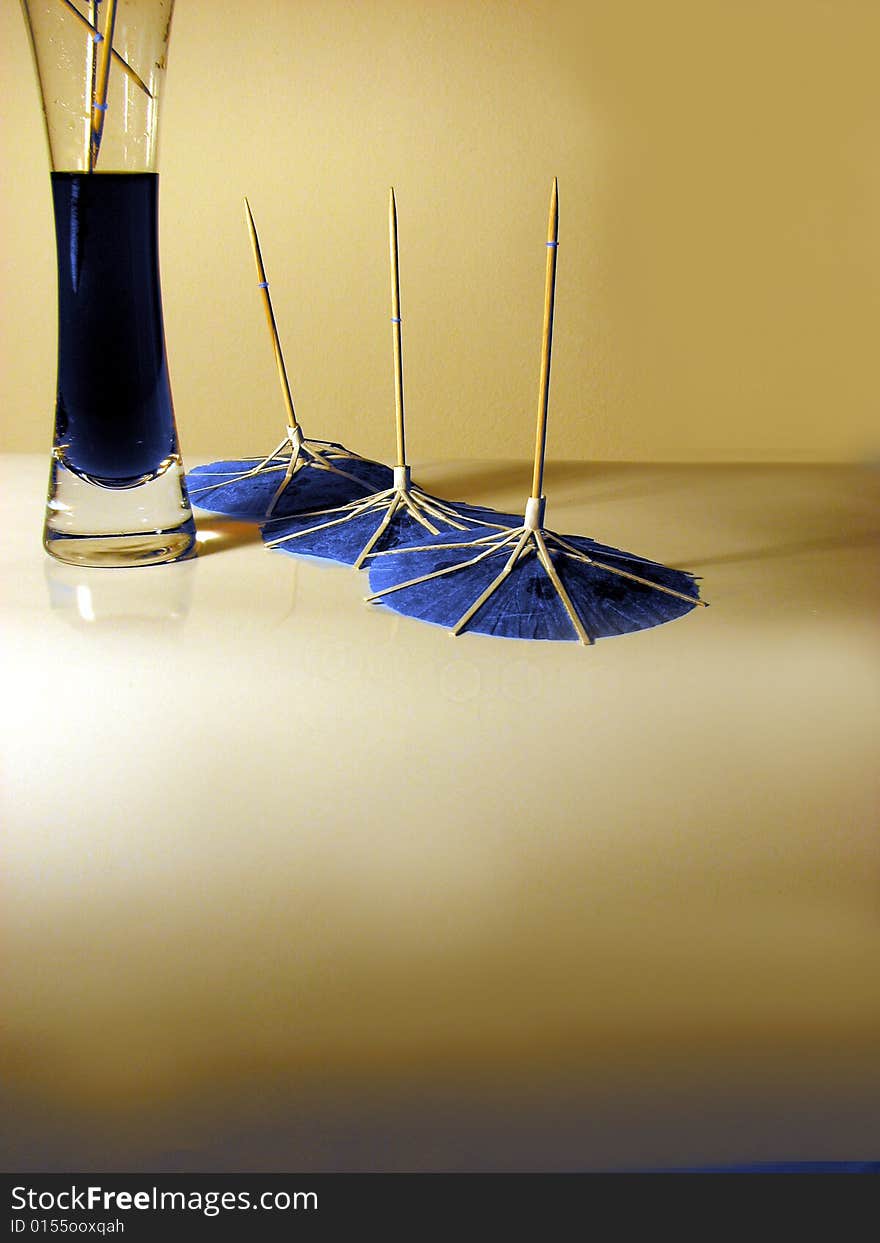 Blue japanese umbrellas next to party drink. Blue japanese umbrellas next to party drink.