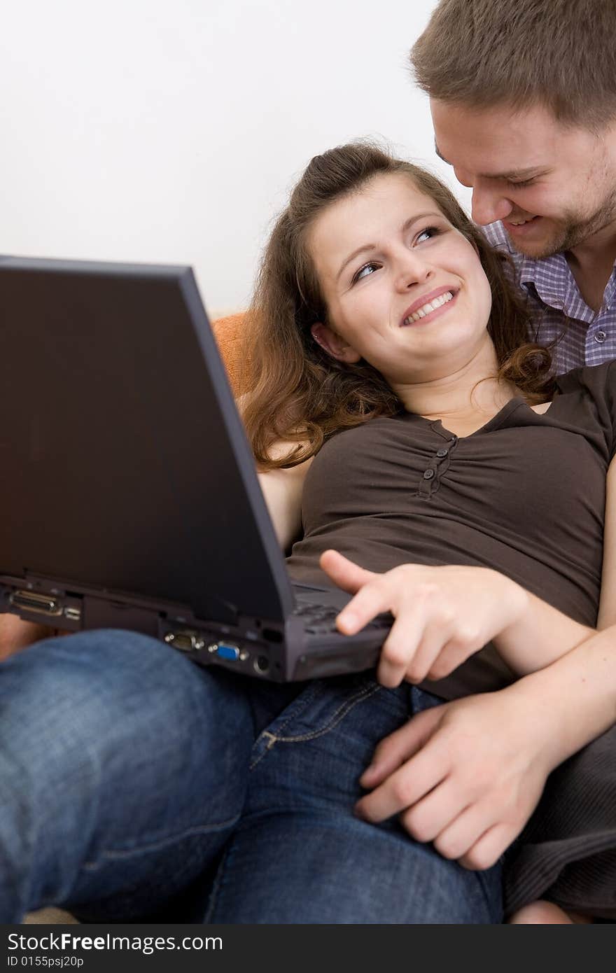 Casual loving couple on sofa with laptop. Casual loving couple on sofa with laptop