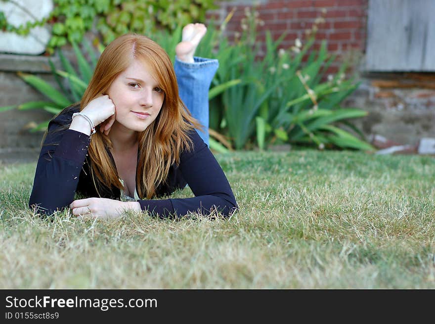 Girl Poses For Camera On Lawn