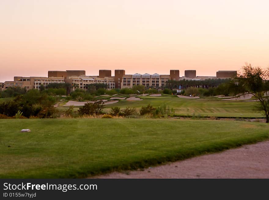 Golf course in the Arizona desert with mountains in the late afternoon sun