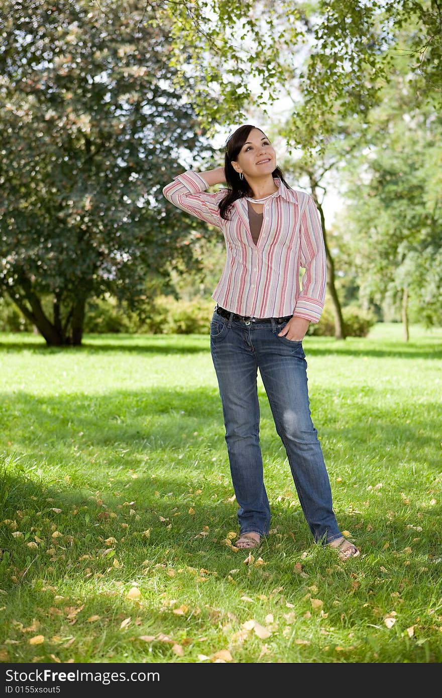 Attractive brunette woman in park. Attractive brunette woman in park