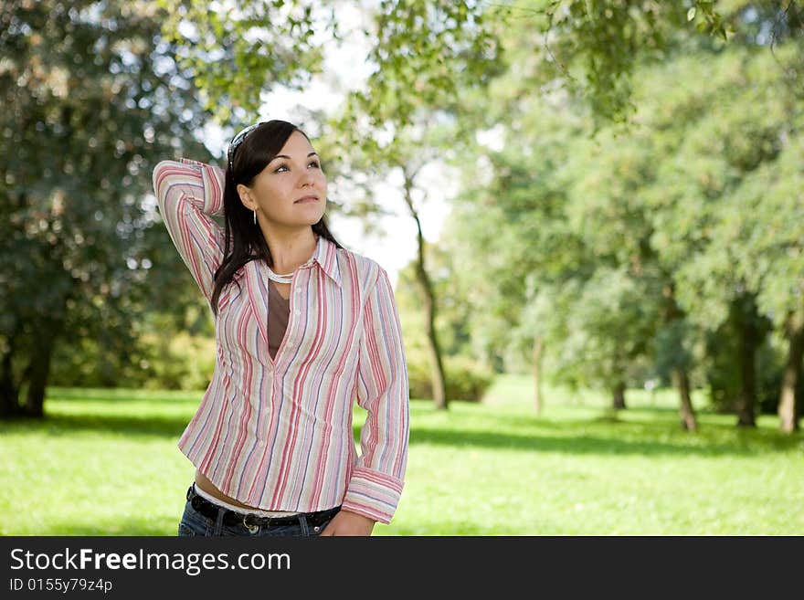 Attractive brunette woman in park. Attractive brunette woman in park