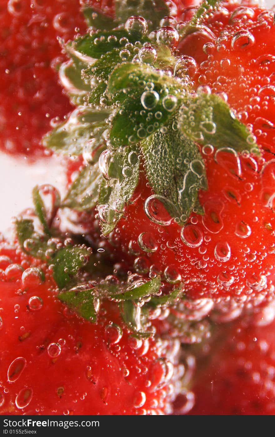 Close up photo of strawberries under the water