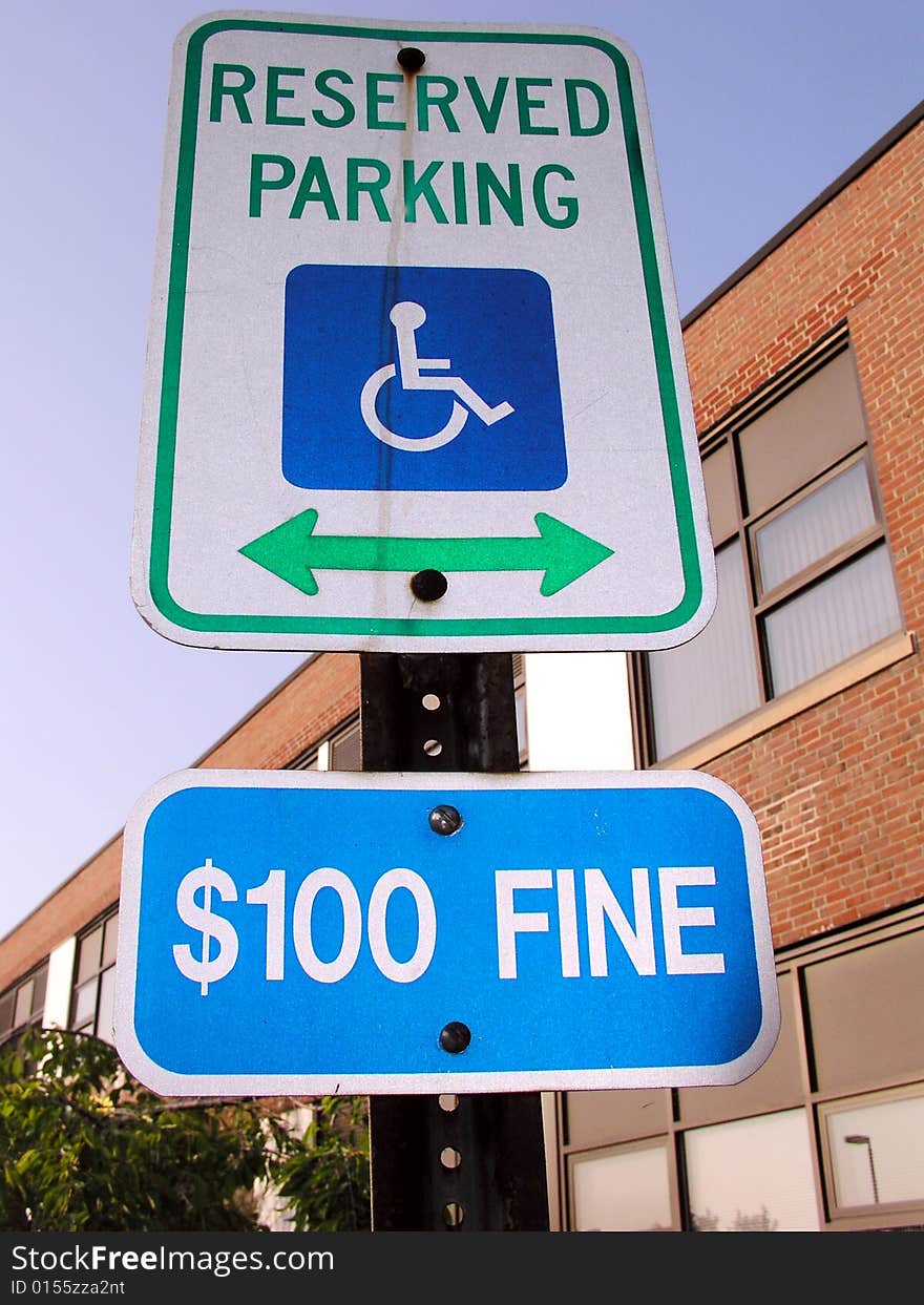 Handicap parking sign with $100 fine sign as well. Handicap parking sign with $100 fine sign as well.