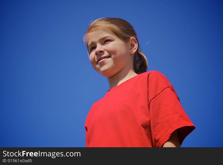 A little girl smiling on a beautiful day. A little girl smiling on a beautiful day.