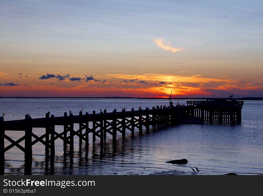 Colorful sun setting over a pier at Long Beach Island. Colorful sun setting over a pier at Long Beach Island