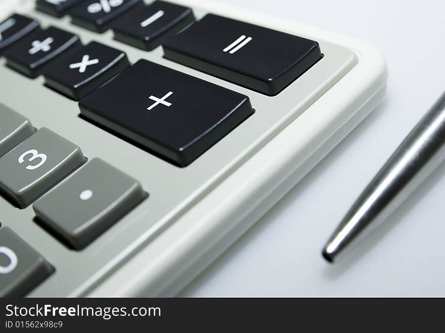 Calculator And Pen On White Background.