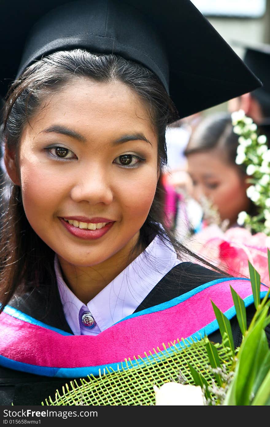 Beautiful Asian university graduates celebrate their success.