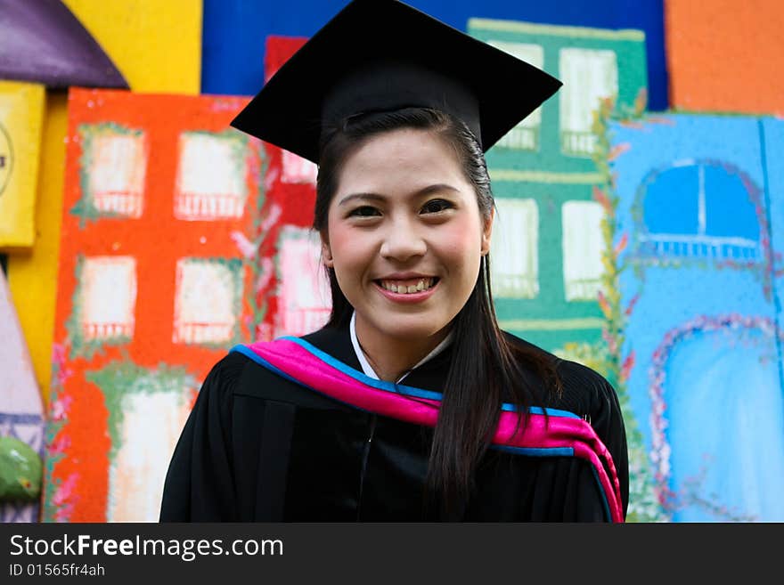 Beautiful Asian university graduates celebrate their success.