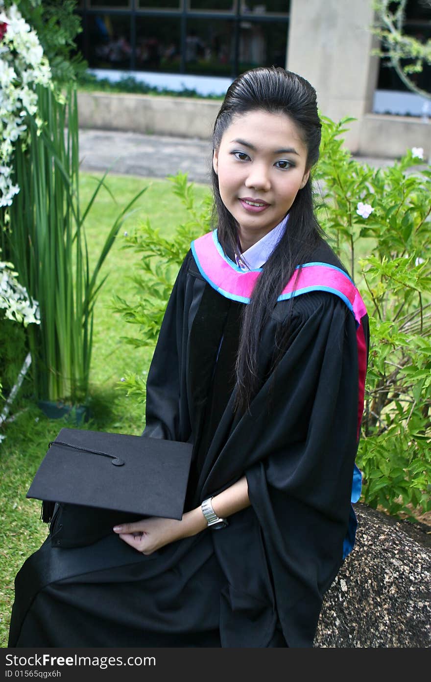 Beautiful Asian university graduates celebrate their success.