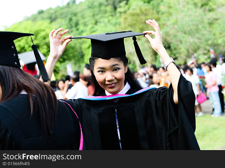 Beautiful Asian university graduates celebrate their success.