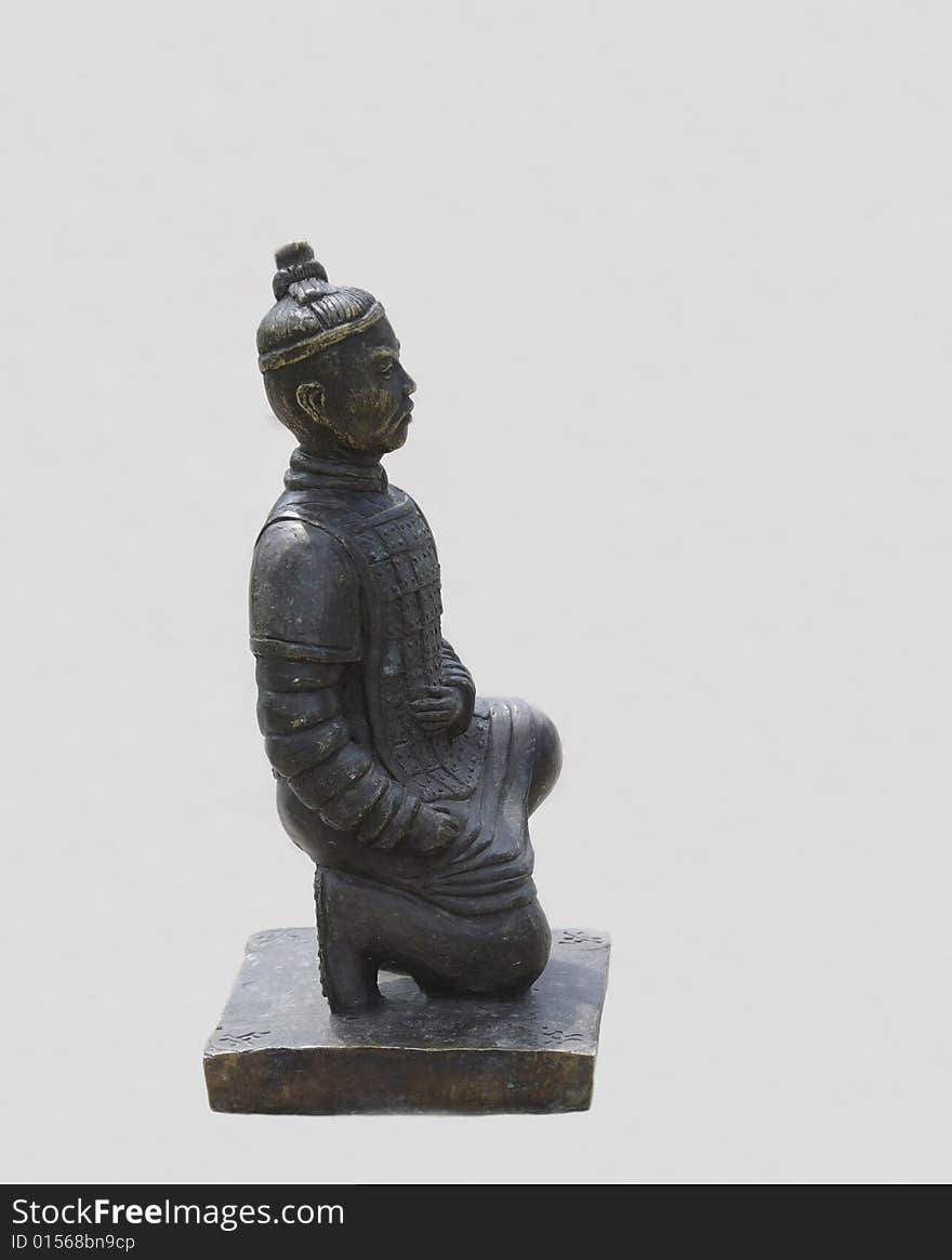 Weathered bronze pawn of old Chinese chess in a shape of ancient warrior isolated on white. Weathered bronze pawn of old Chinese chess in a shape of ancient warrior isolated on white