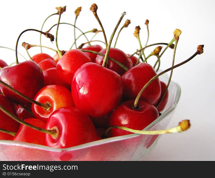 Tasty cherries in glass bowl