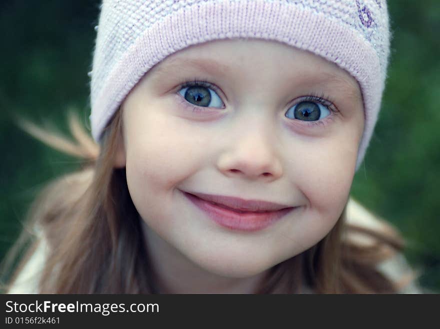 Little girl in a lilac hat