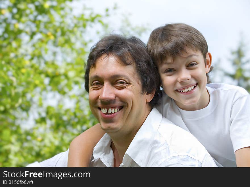 Portrait of young happy father getting  busy with his son. Portrait of young happy father getting  busy with his son