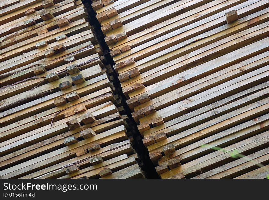 Pile of wood in the afternoon sun on the construction site