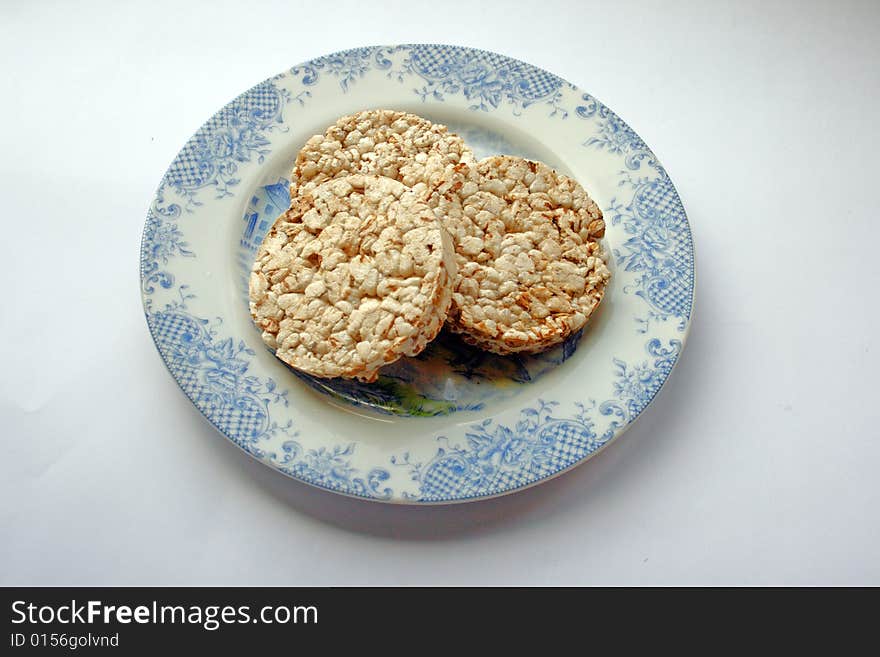 Crackers on porcelan plate on white background. Crackers on porcelan plate on white background