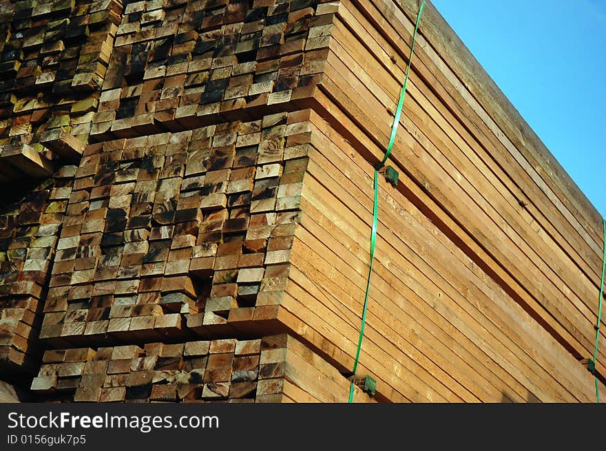 Pile of wood in the afternoon sun on the construction site