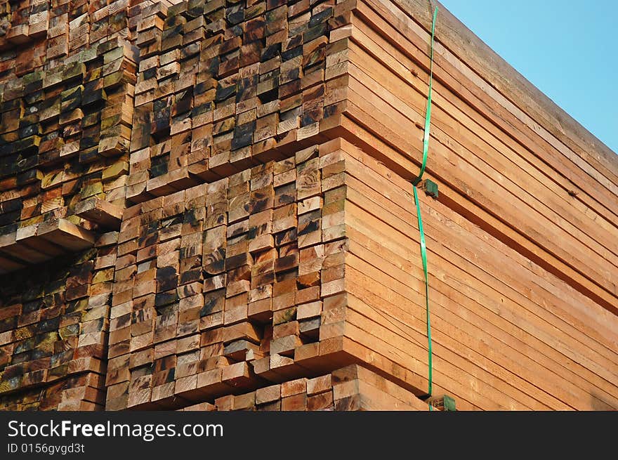 Pile of wood in the afternoon sun on the construction site