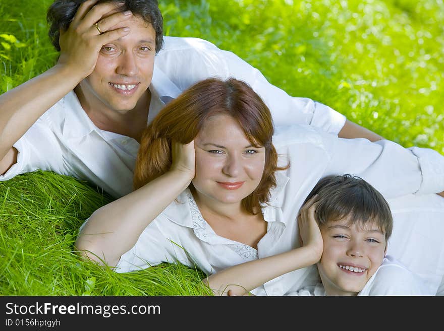 Portrait of young happy family in summer environment. Portrait of young happy family in summer environment