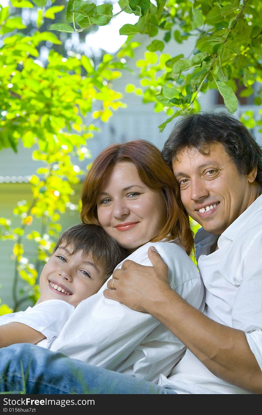 Portrait of young happy family in summer environment. Portrait of young happy family in summer environment