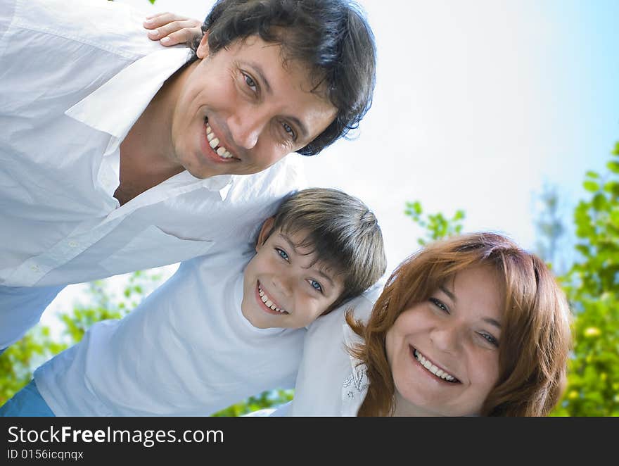 Portrait of young happy family in summer environment. Portrait of young happy family in summer environment