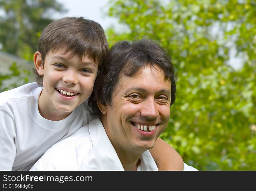 Portrait of young happy father getting  busy with his son. Portrait of young happy father getting  busy with his son