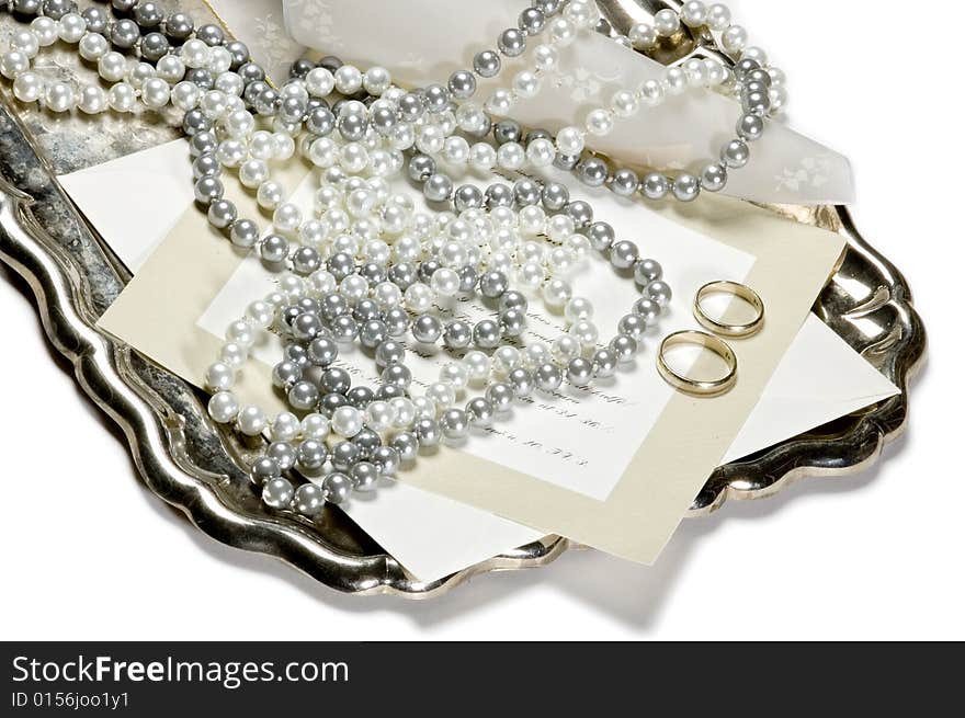 Two wedding rings with invitation card on an antic silver tray. Two wedding rings with invitation card on an antic silver tray