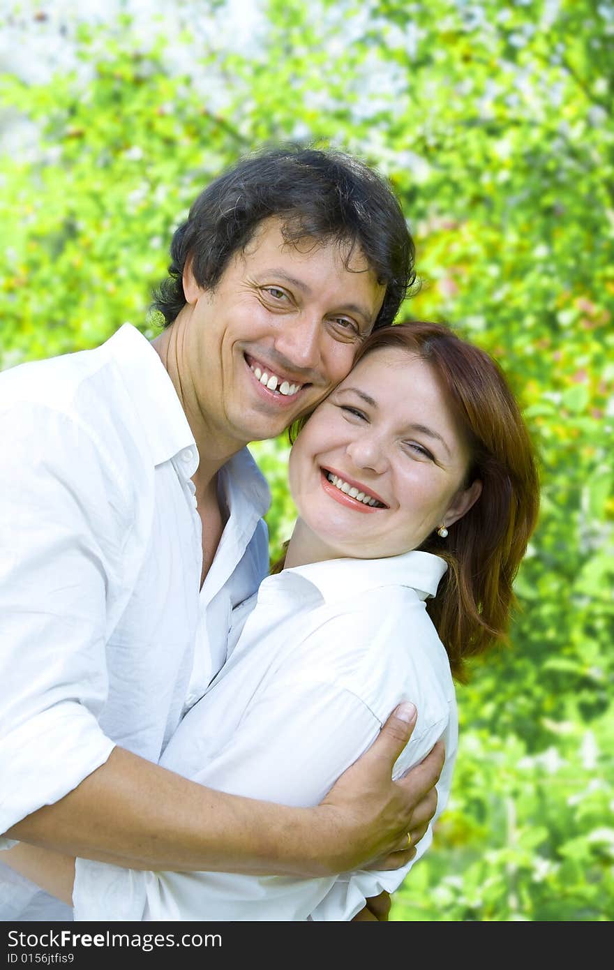 Portrait of young happy couple in summer environment. Portrait of young happy couple in summer environment