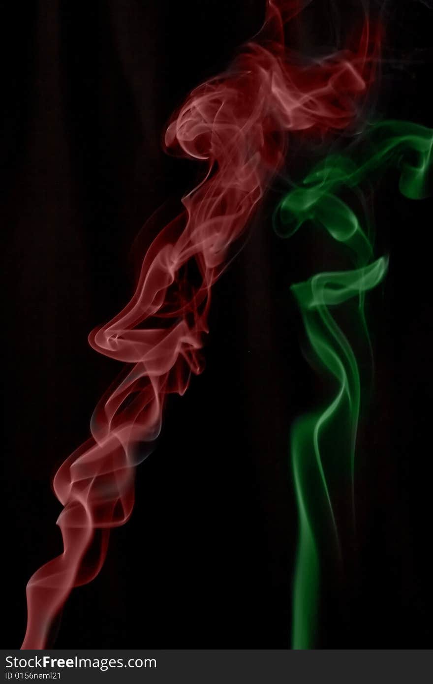 Red and green smokes on the black background.