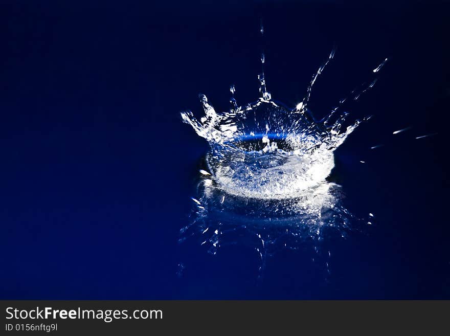 Sparks of deep blue water on black background. Sparks of deep blue water on black background