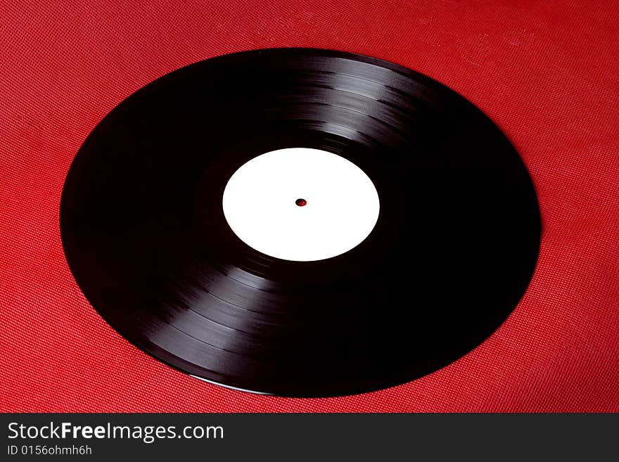 Vinyl record with white label on red ground