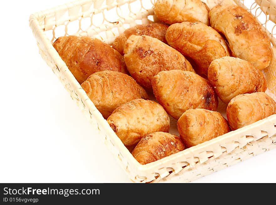 Croissants in basket isolated on white background. Croissants in basket isolated on white background