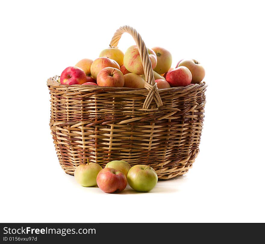 Apples in woven basket isolated on white background