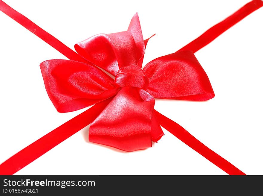 Red satin bow with ribbon isolated on white