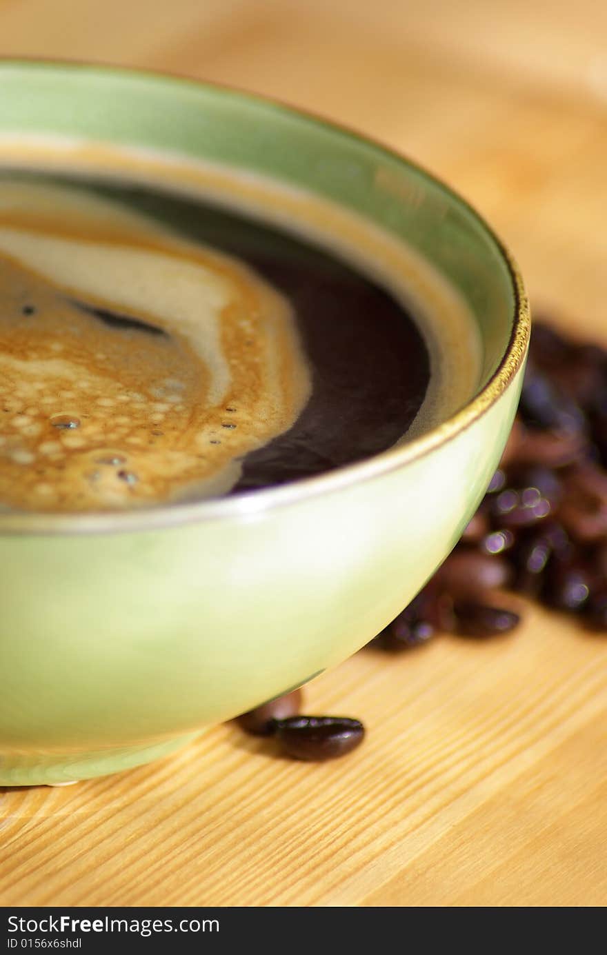 Green cup of coffee on the wood table. Green cup of coffee on the wood table