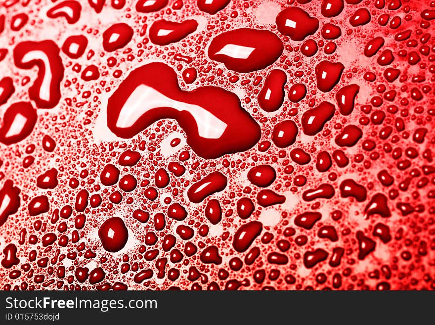 Some water drops on red background