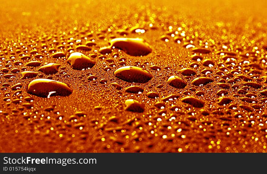 Some water drops on golden background